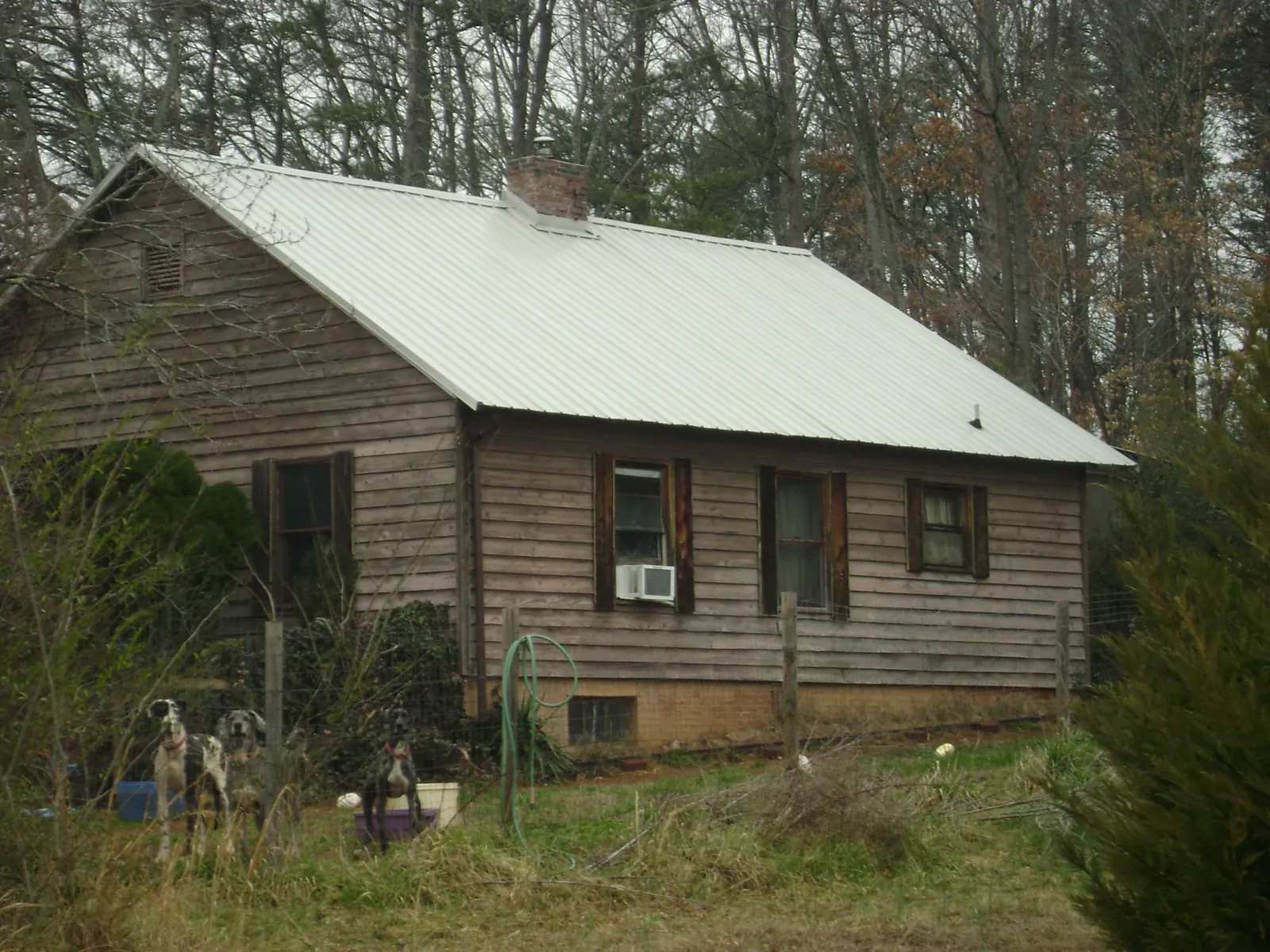 White metal roof on an old wood sided farmhouse, from a Metal Roof Installation job in Dry Ridge